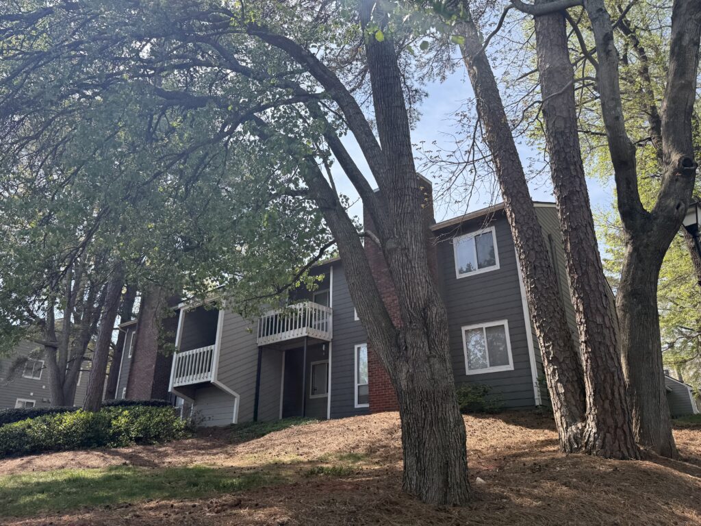 Exterior view of Heathstead Apartments buildings with brick facades, balconies, and landscaped grounds
